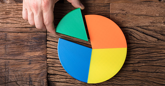 person placing a piece of a pie chart to make a whole pie